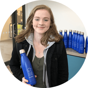 Lady holding Nido student branded bottle
